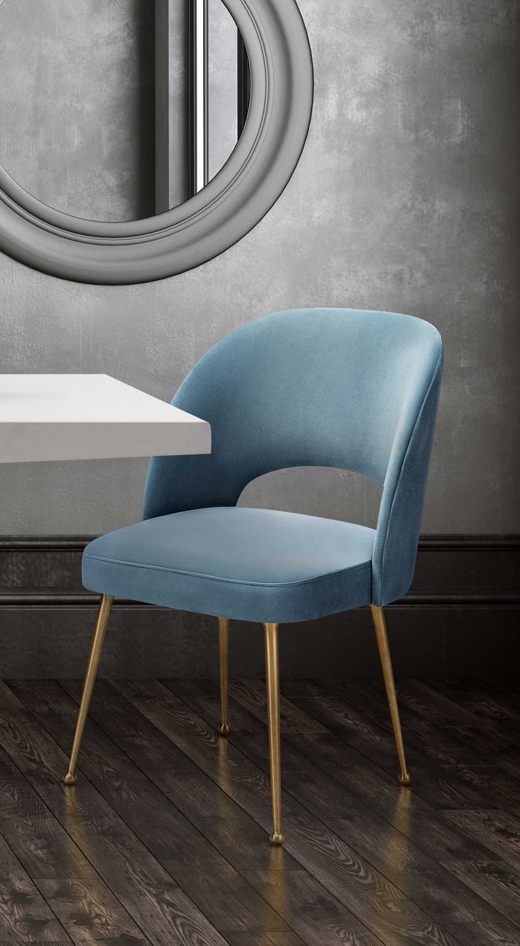 An armless sea blue velvet chair brings plush comfort and golden accents to a cozy dining nook