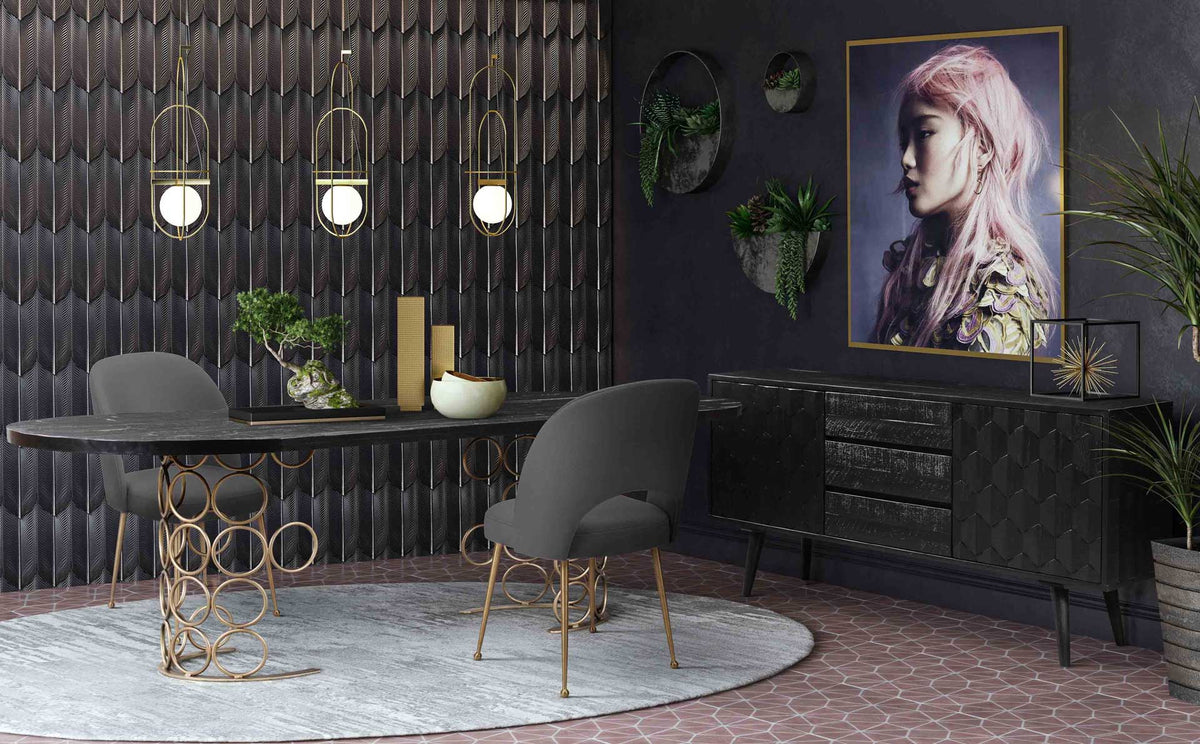 Dark gray velvet chairs and gold legs create an elegant pairing with a dramatic black dining table