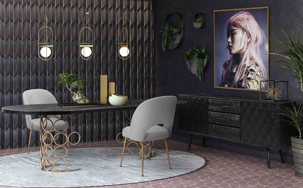 Light gray velvet chairs offer a soft neutral accent against a dramatic black dining room