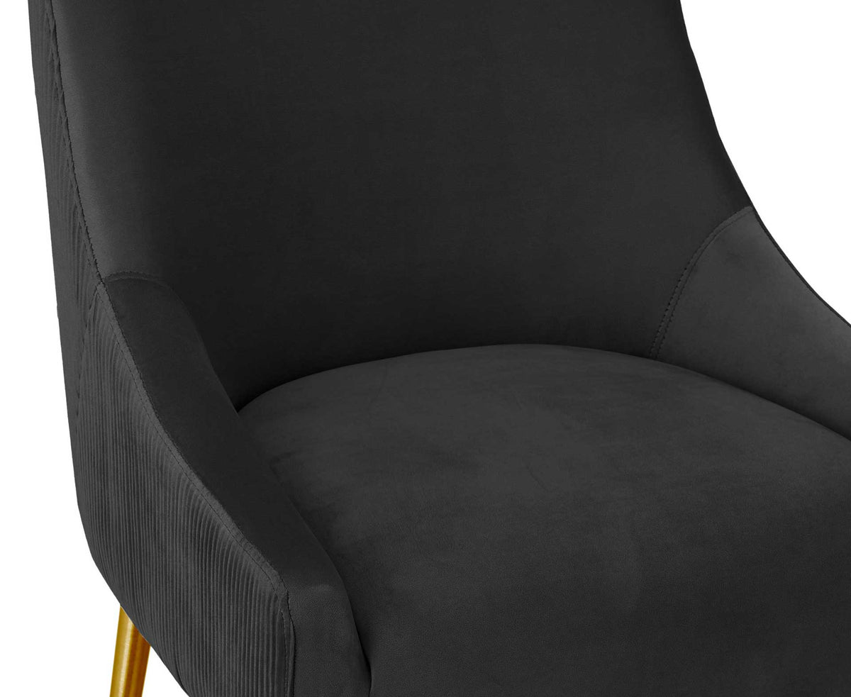 Thick black velvet cushioning and softly curved arms create an inviting place to sit
