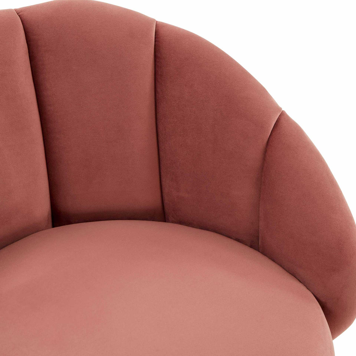 Rich salmon velvet and sculpted vertical channels create a softly cushioned seat with curved arms