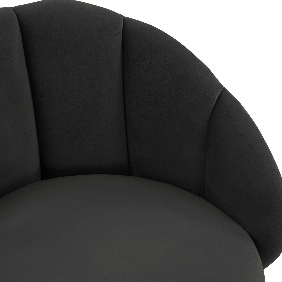 Plush black velvet frames the padded seat with softly curved arms and vertical channel stitching