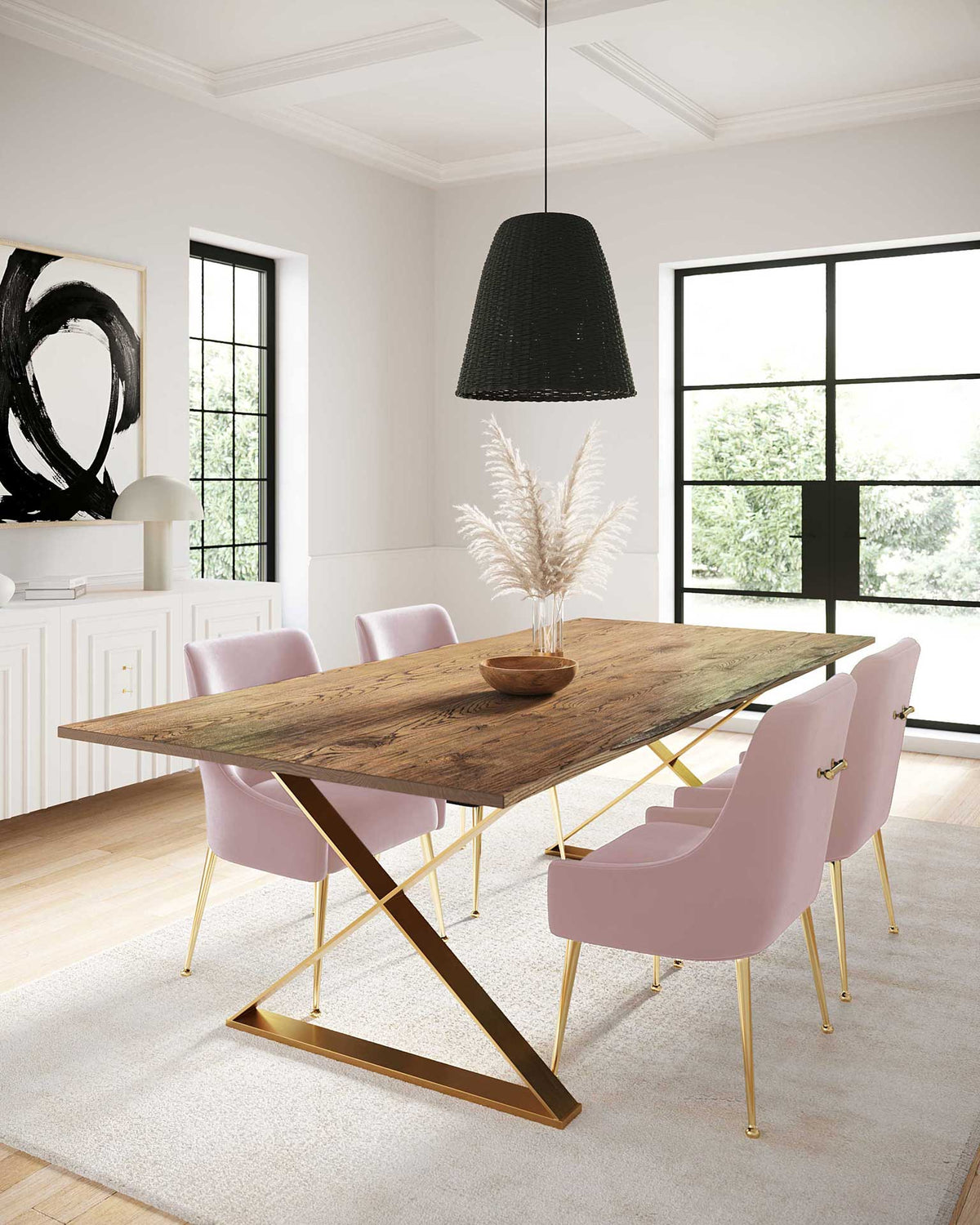 Sculpted blush velvet chairs pair soft curves and gold accents with a warm wood dining table.