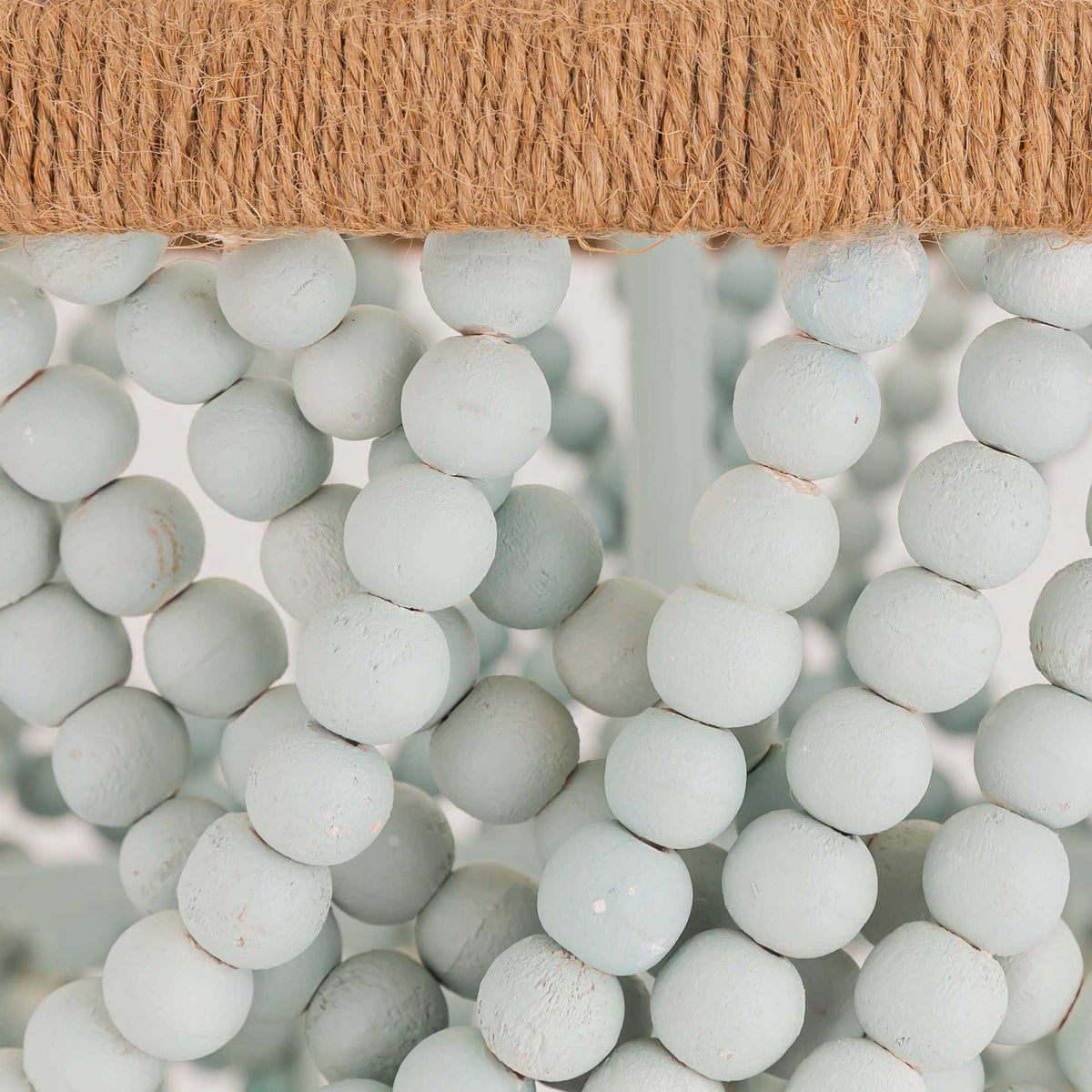 A rope-wrapped ring and pale mint wood beads combine natural texture with soft, coastal-inspired color.