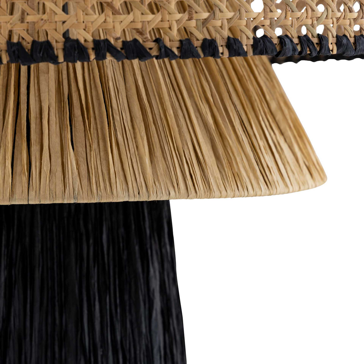 Flared natural raffia strands contrast with a black lower shade for rich, layered texture