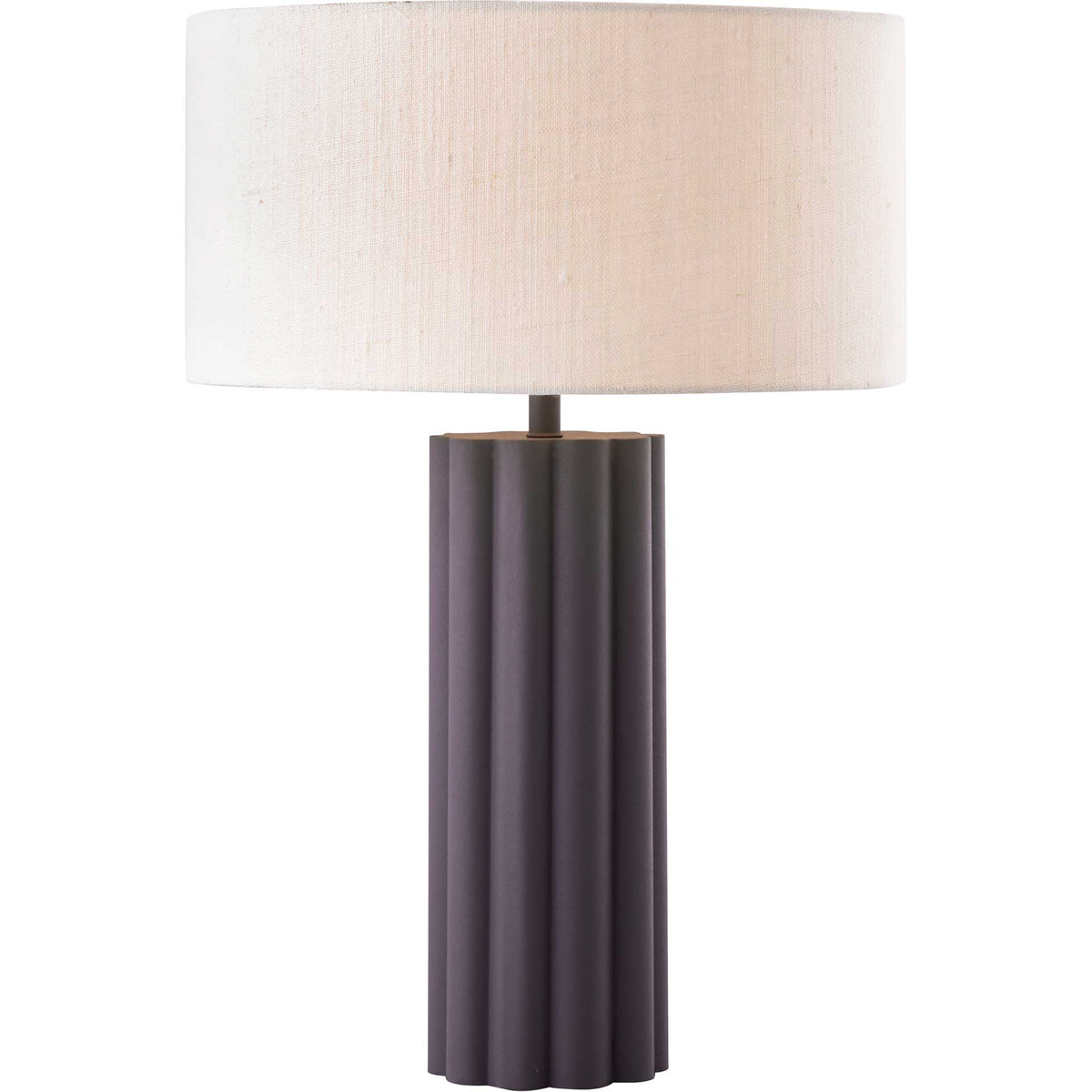 Warm light glows through the linen shade above a deep gray, fluted iron base.