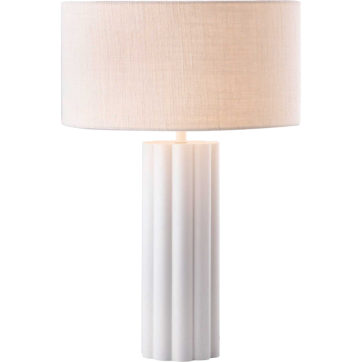 A softly glowing linen shade casts warm light over a cream fluted column.