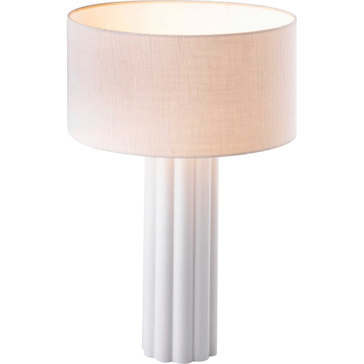 A broad linen drum shade balances the tall, sculpted cream base with a warm glow.