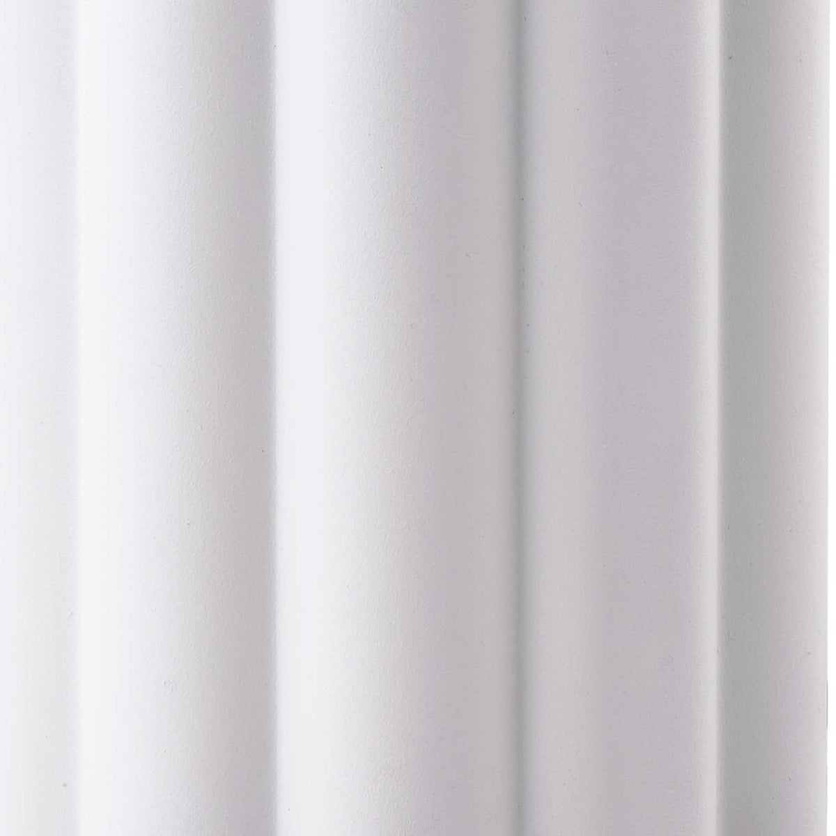 Rounded vertical flutes give the cream iron base a smooth, sculptural rhythm.