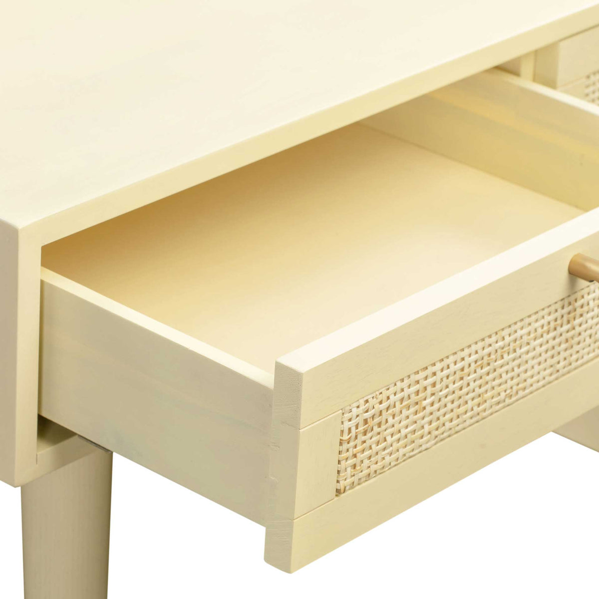 A generous cream drawer keeps supplies close at hand behind a delicately woven cane front.