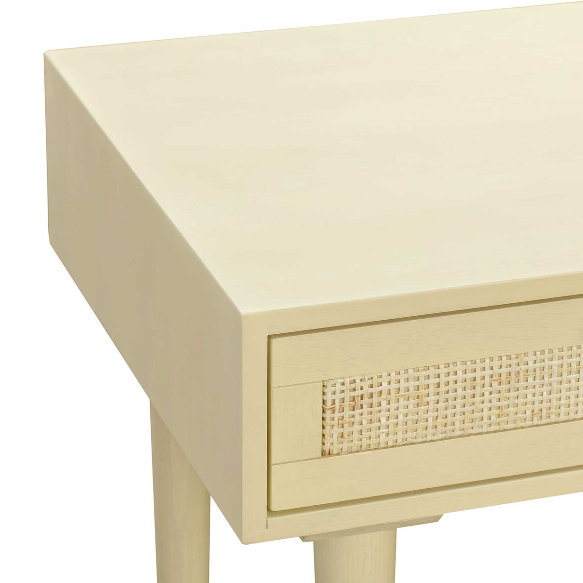A smooth cream desktop and framed cane drawer panel combine crisp lines with subtle texture.