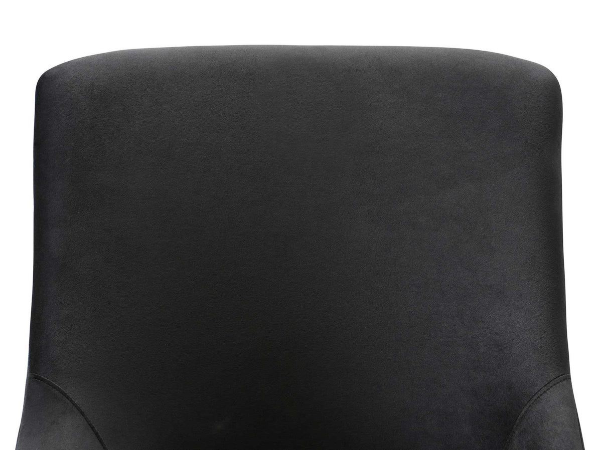 Smooth black velvet wraps a softly curved backrest with neatly tailored seams
