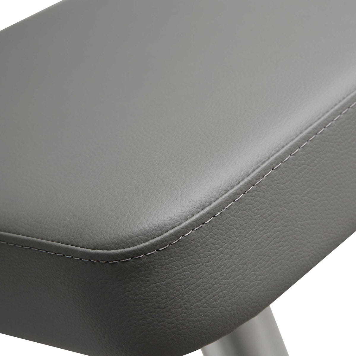Textured gray vegan leather wraps a thick seat cushion with tailored edge stitching