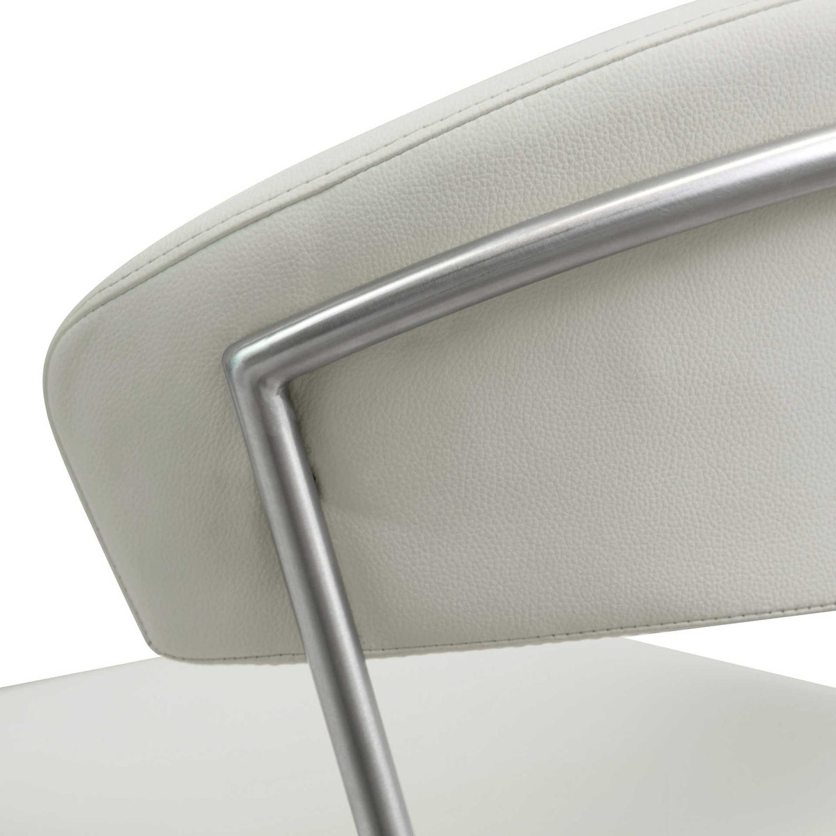 A slender steel outline contrasts with the soft curve and fine grain of the light gray padded backrest