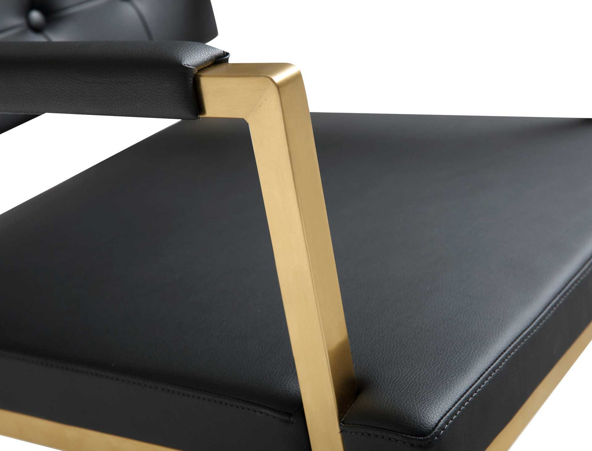 Stitched black vegan leather and a squared gold arm support create a crisp, tailored finish