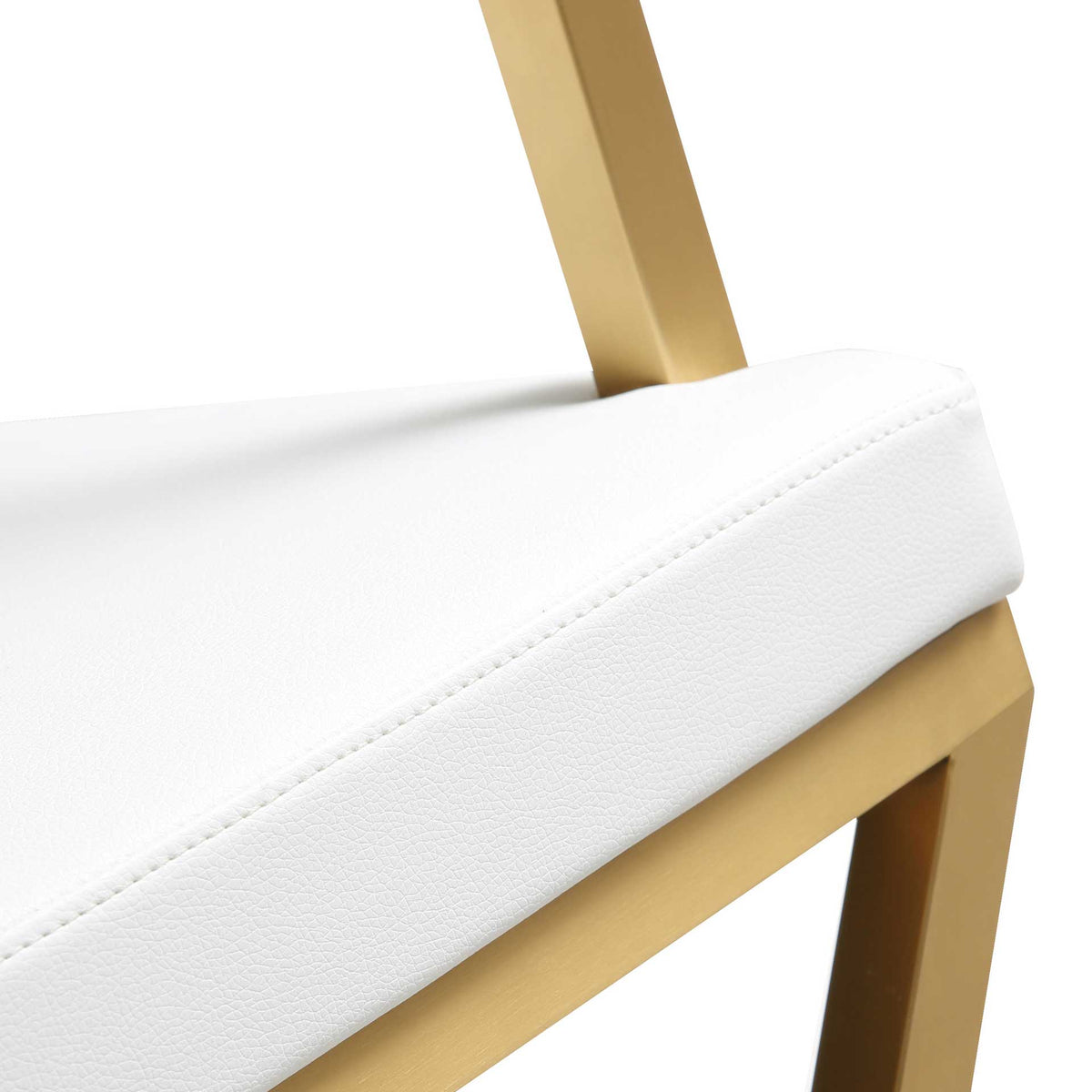 Neatly stitched white seat edges contrast with the warm sheen of the gold stainless steel frame