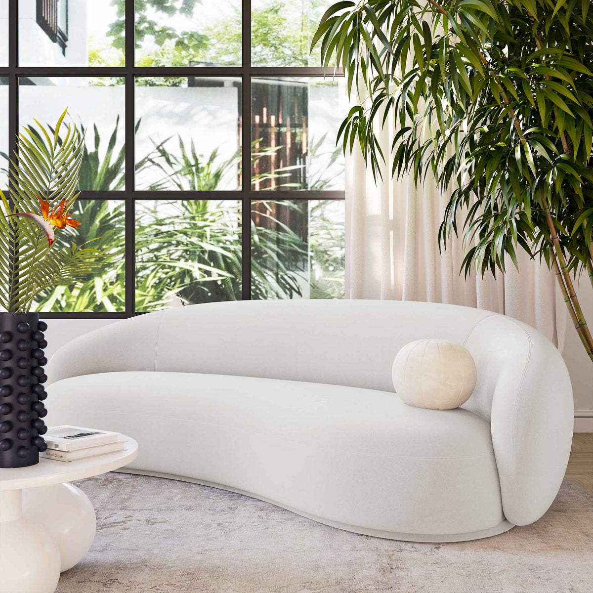 This cream velvet sofa brings soft curves and a light, airy look to a contemporary living space