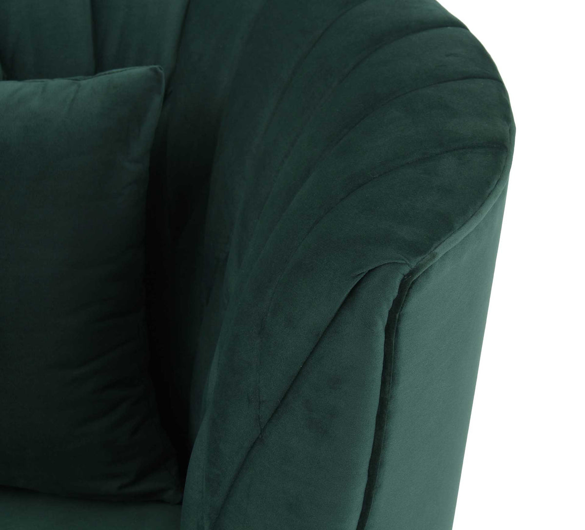 Rich forest green velvet softens a curved arm accented with crisp, angled channel stitching.