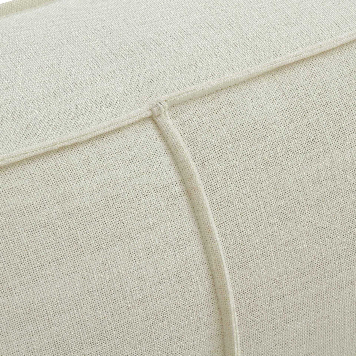Textured cream linen and neatly joined piping add a tailored touch to the upholstery