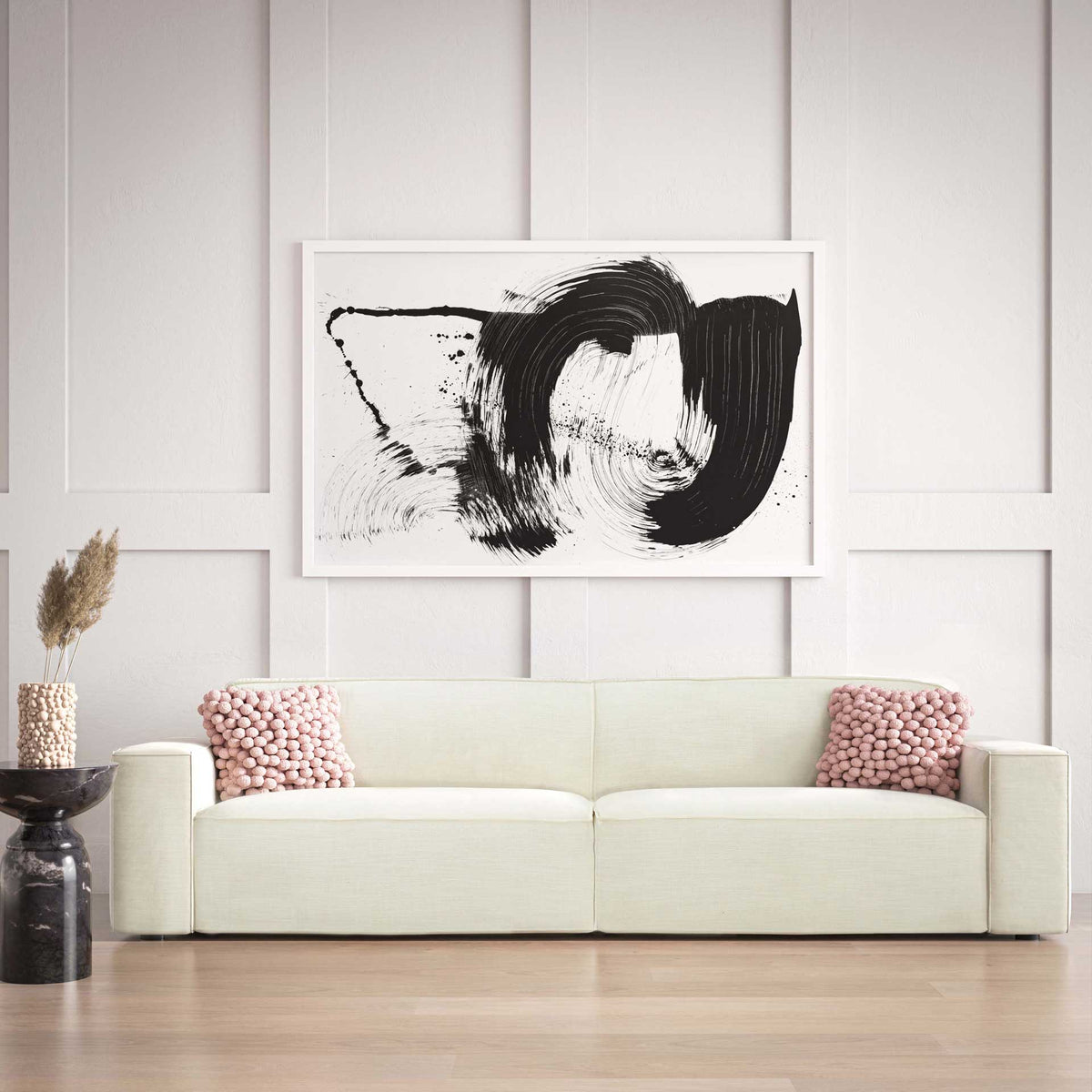 Soft cream upholstery and broad arms make this streamlined sofa an inviting living room centerpiece
