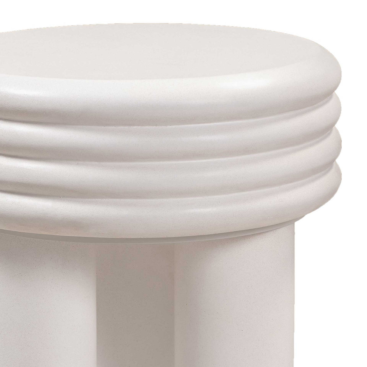 Smooth, rounded rings add sculptural texture to the thick ivory concrete tabletop