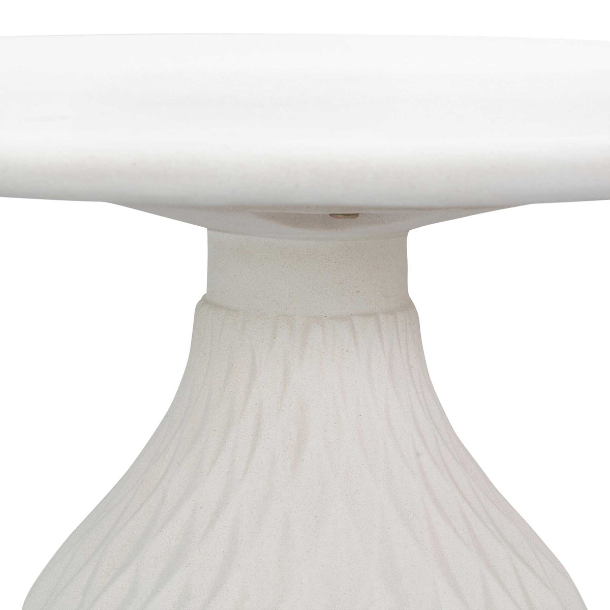 A slender ivory neck connects the round concrete top to the gently flared pedestal