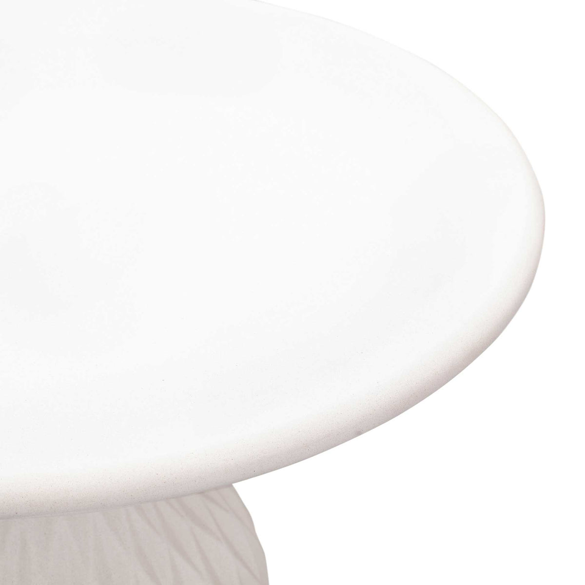 Rounded edges and subtle concrete texture lend the ivory tabletop a refined finish