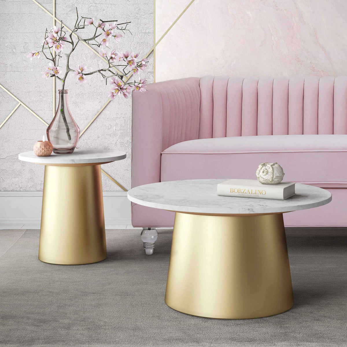 Matching white marble coffee and side tables with gold pedestal bases add cohesive glamour
