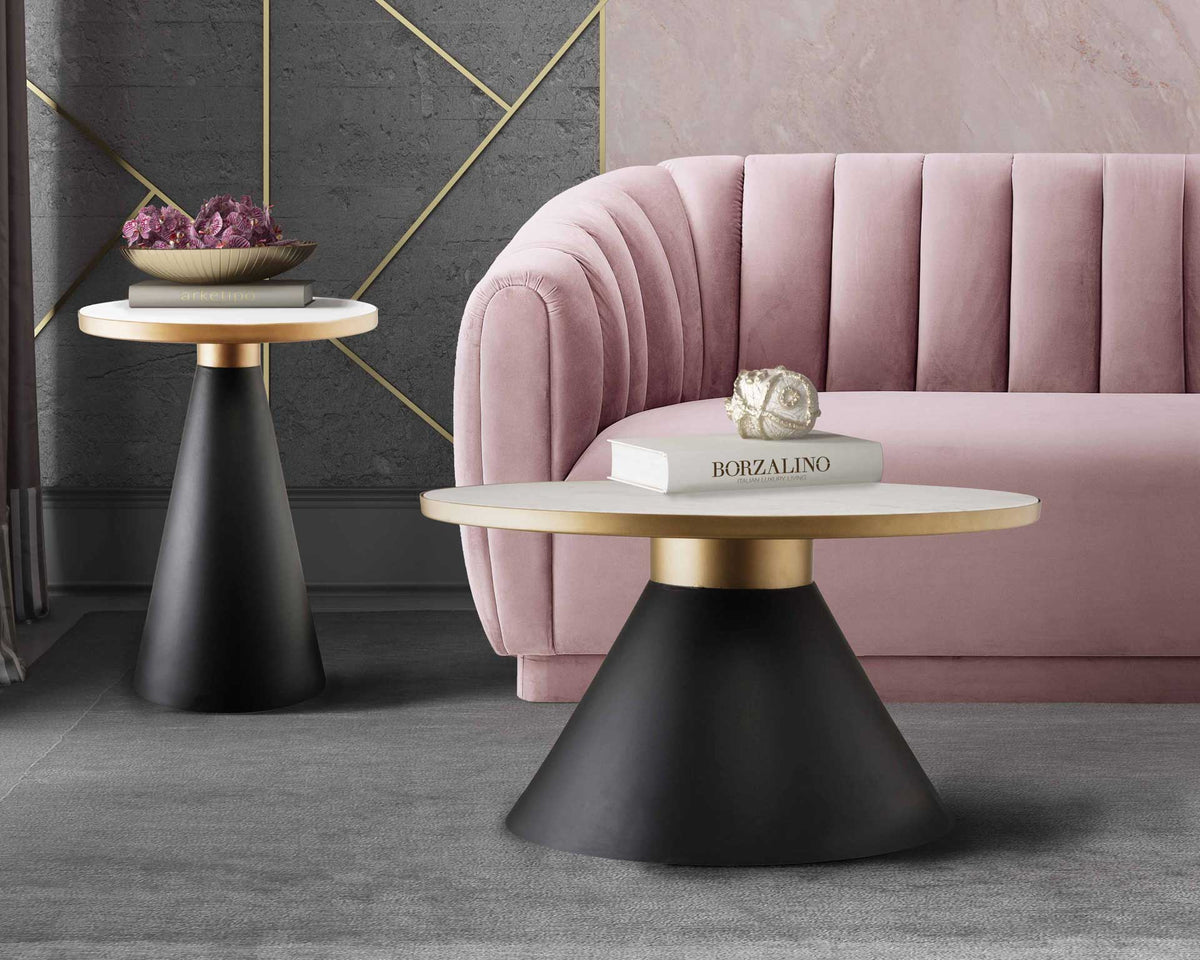 Coordinating marble tables with gold-tone rims and black conical bases bring sculptural style to a lounge