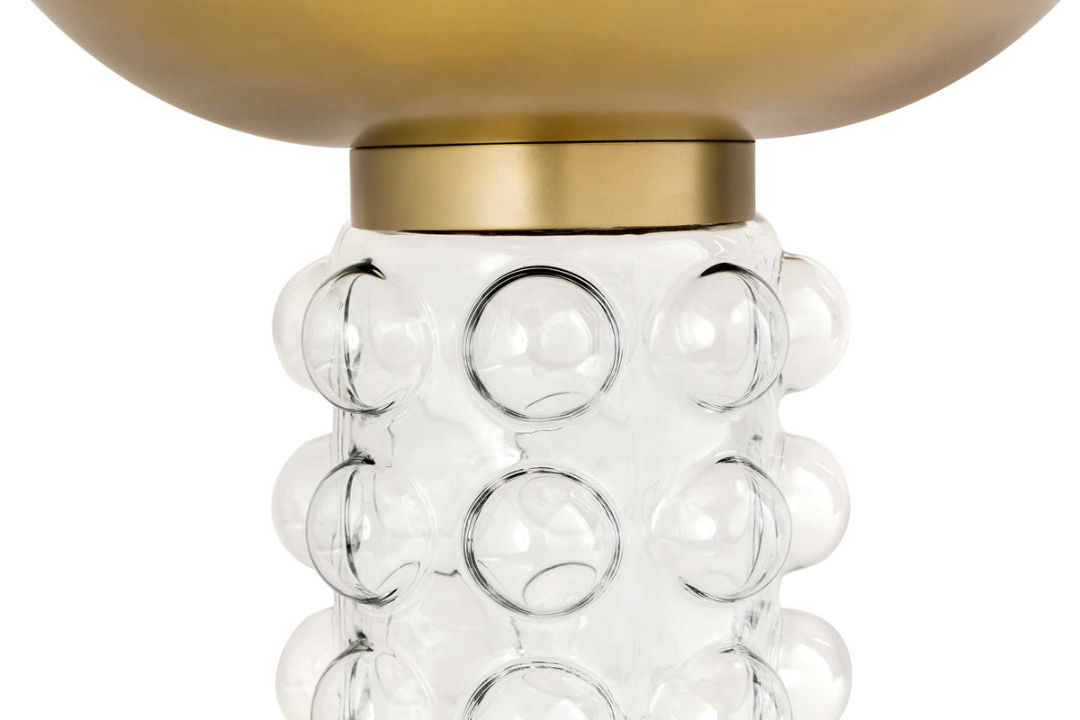 Raised glass bubbles and a brass-finished collar give the transparent pedestal a playful, polished look