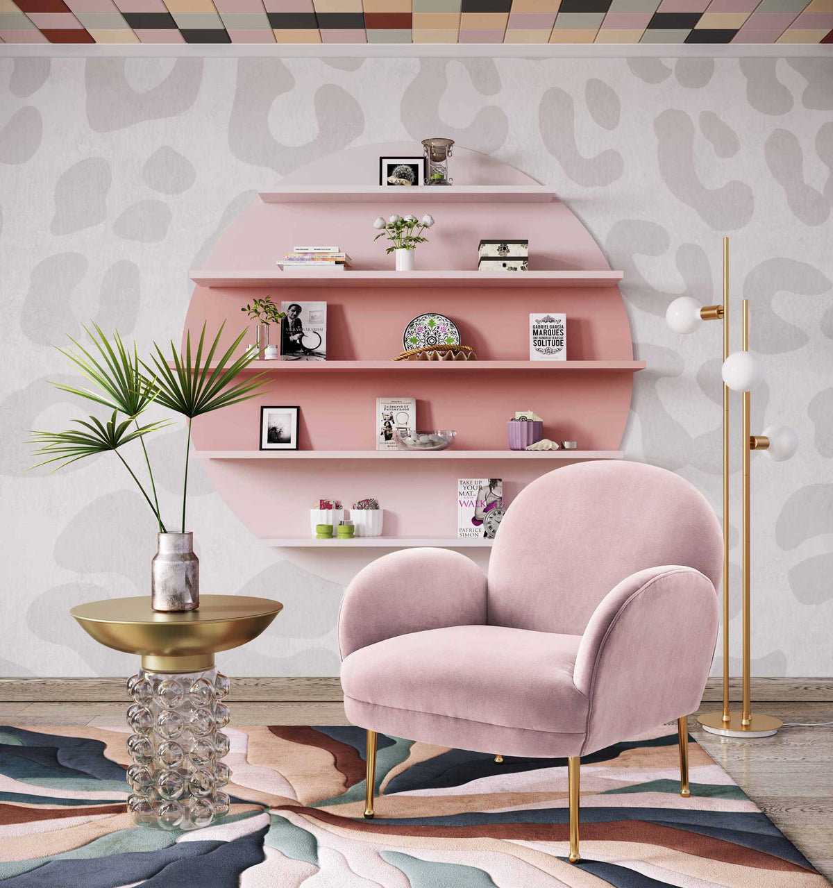 A brass-finished top and clear bubble glass base add sculptural charm beside a blush pink accent chair