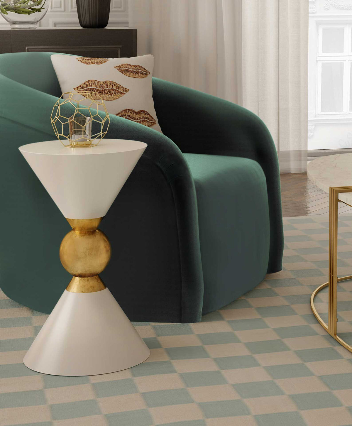 A white side table with a gold spherical center adds a crisp accent beside green upholstery.