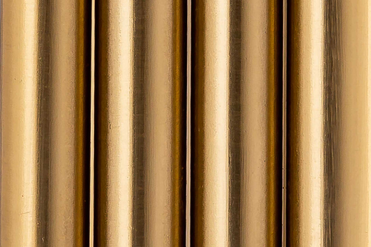 Grouped iron rods create a fluted texture with a luminous satin gold finish.