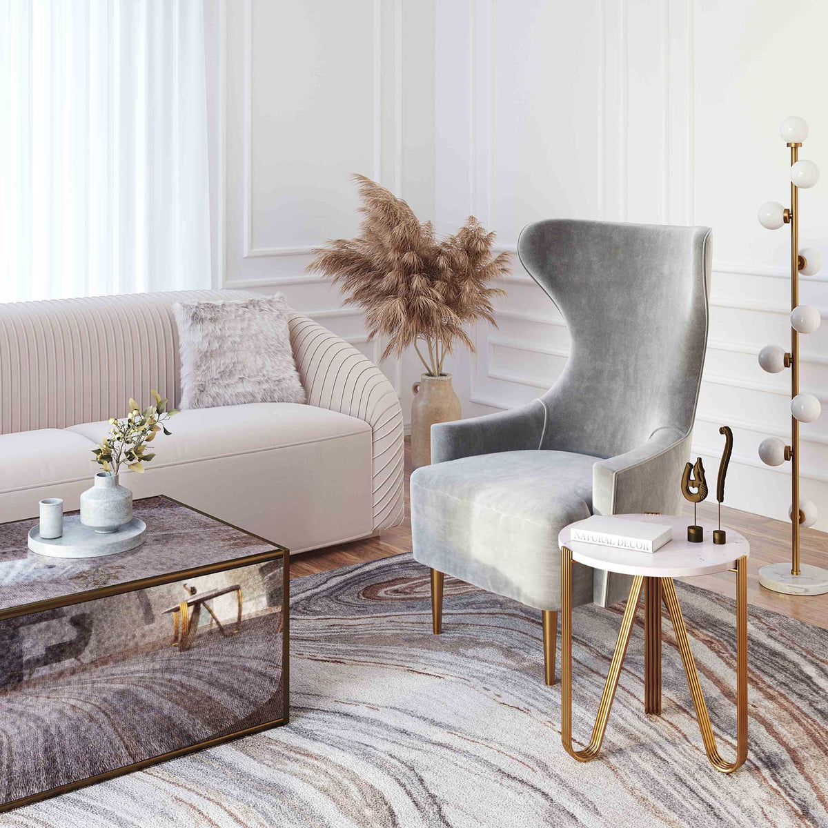 White marble and gold iron add a glamorous finishing touch beside a plush gray accent chair.