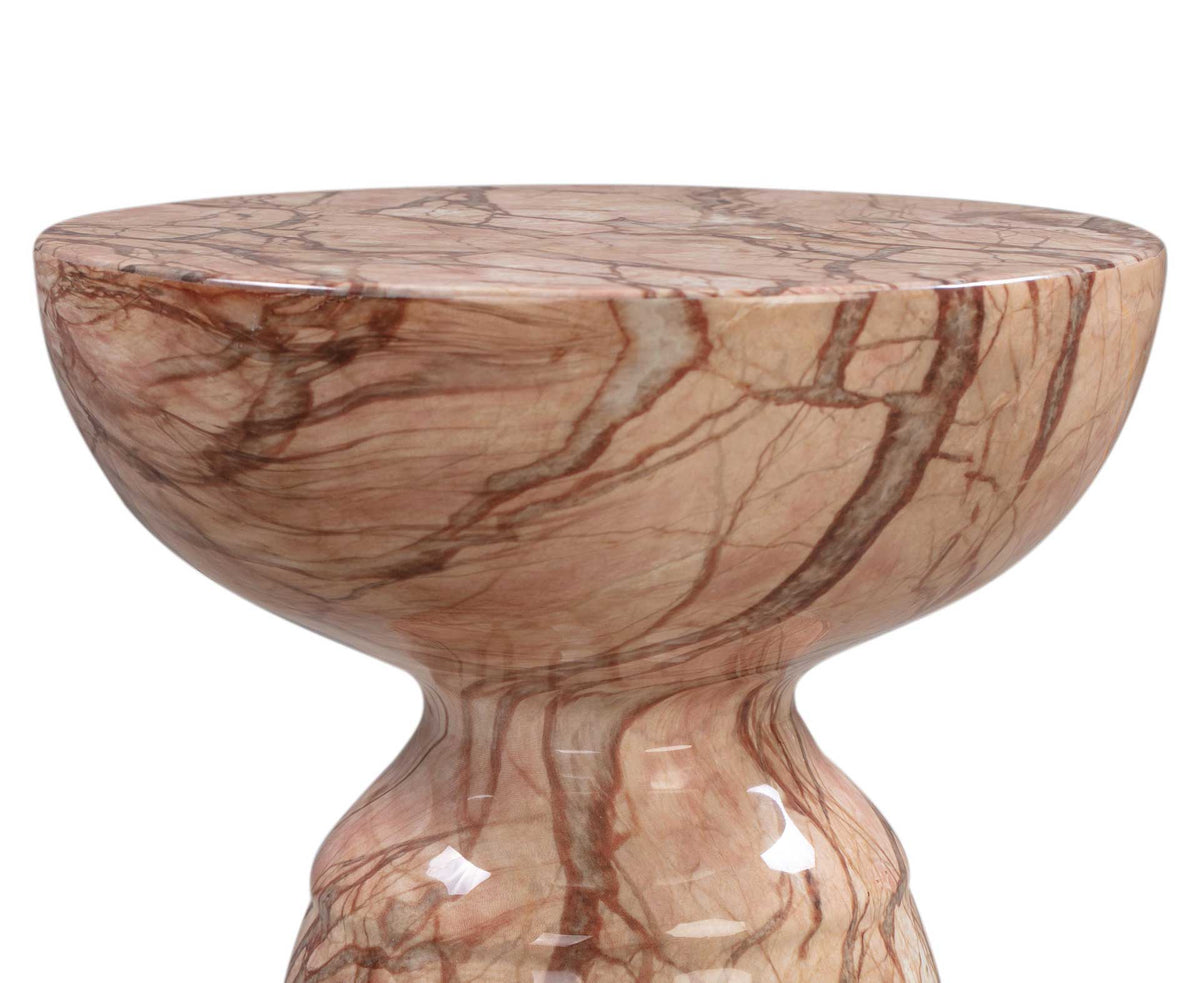 A curved tabletop edge and tapered neck highlight the warm peach marble-look finish and brown veining