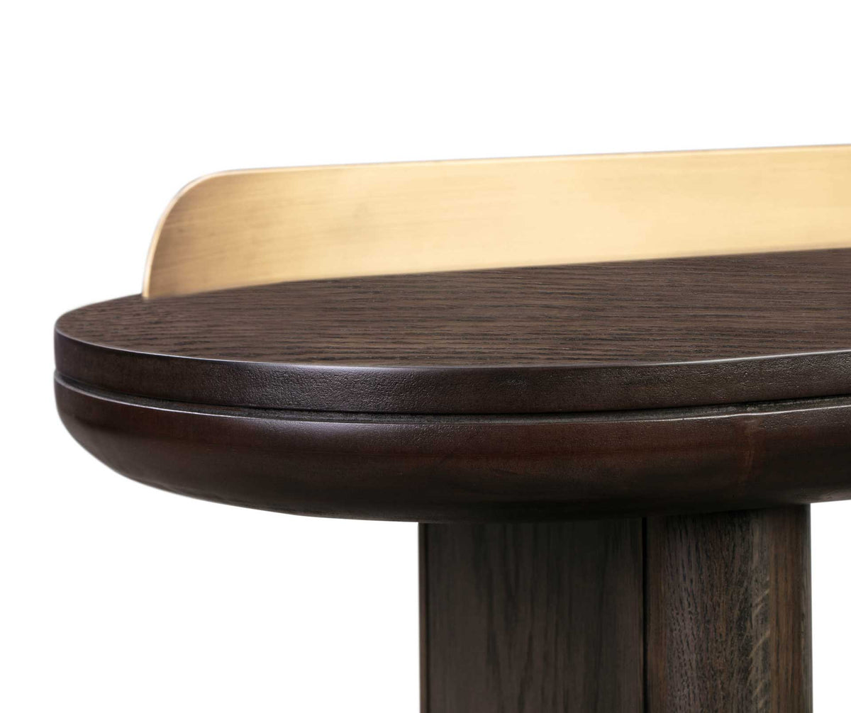 A softly rounded brown tabletop edge pairs with a brushed brass-finished rail for a refined finish