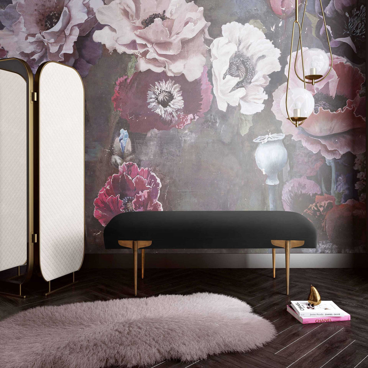 Rich black velvet and warm gold legs bring elegant contrast to a floral-inspired interior.