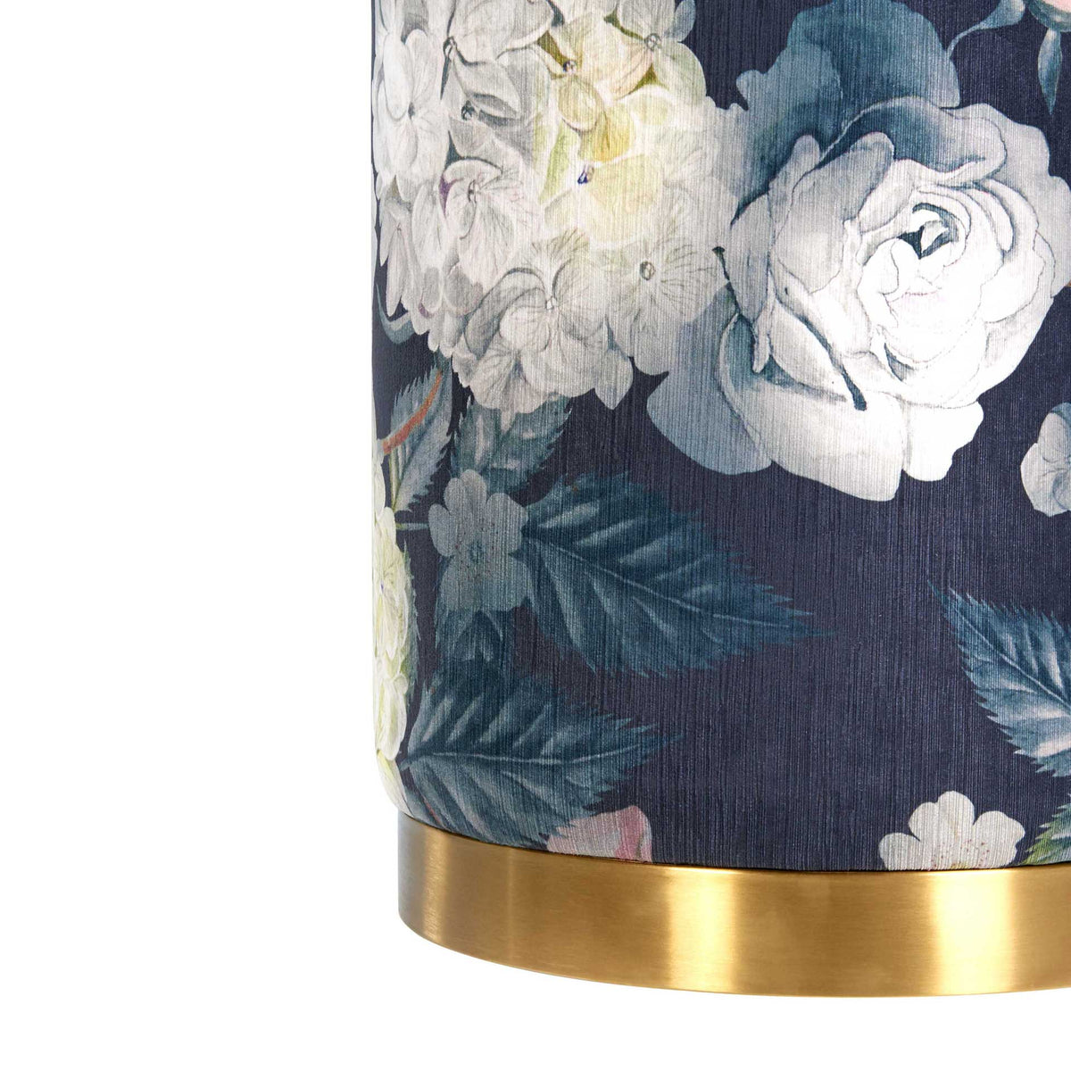 A brushed gold base adds warm contrast to dark velvet patterned with delicate blooms.