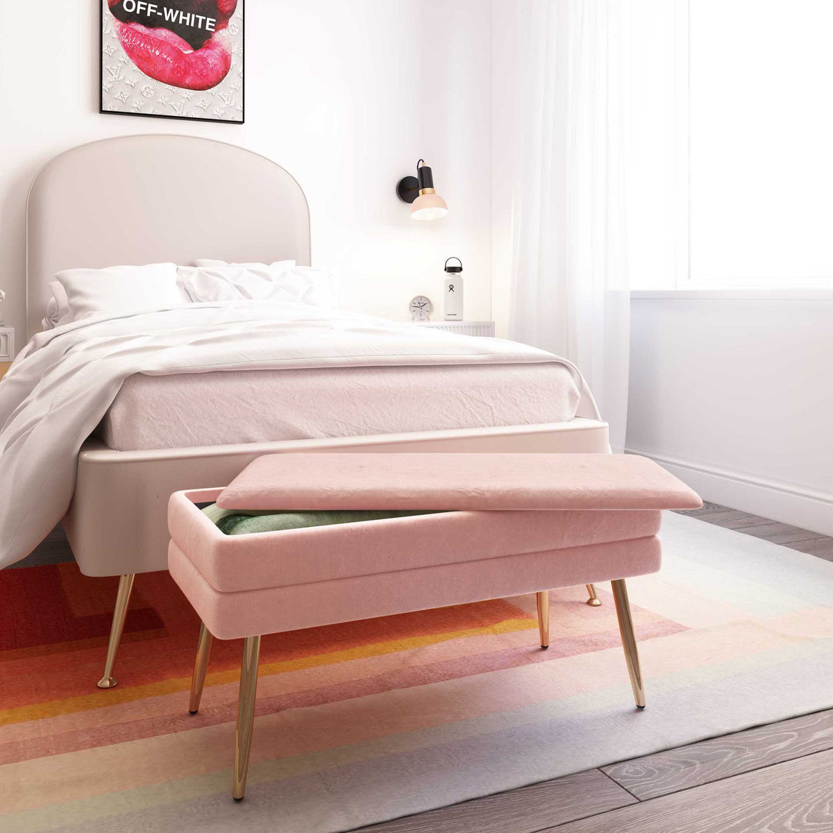 A blush velvet bench pairs end-of-bed seating with handy storage beneath its cushioned lid