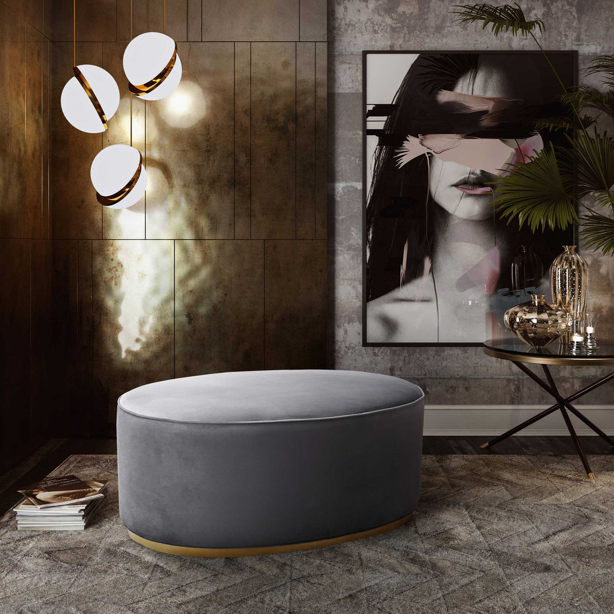 A plush gray velvet ottoman with a gold base adds elegant extra seating to a contemporary living space.