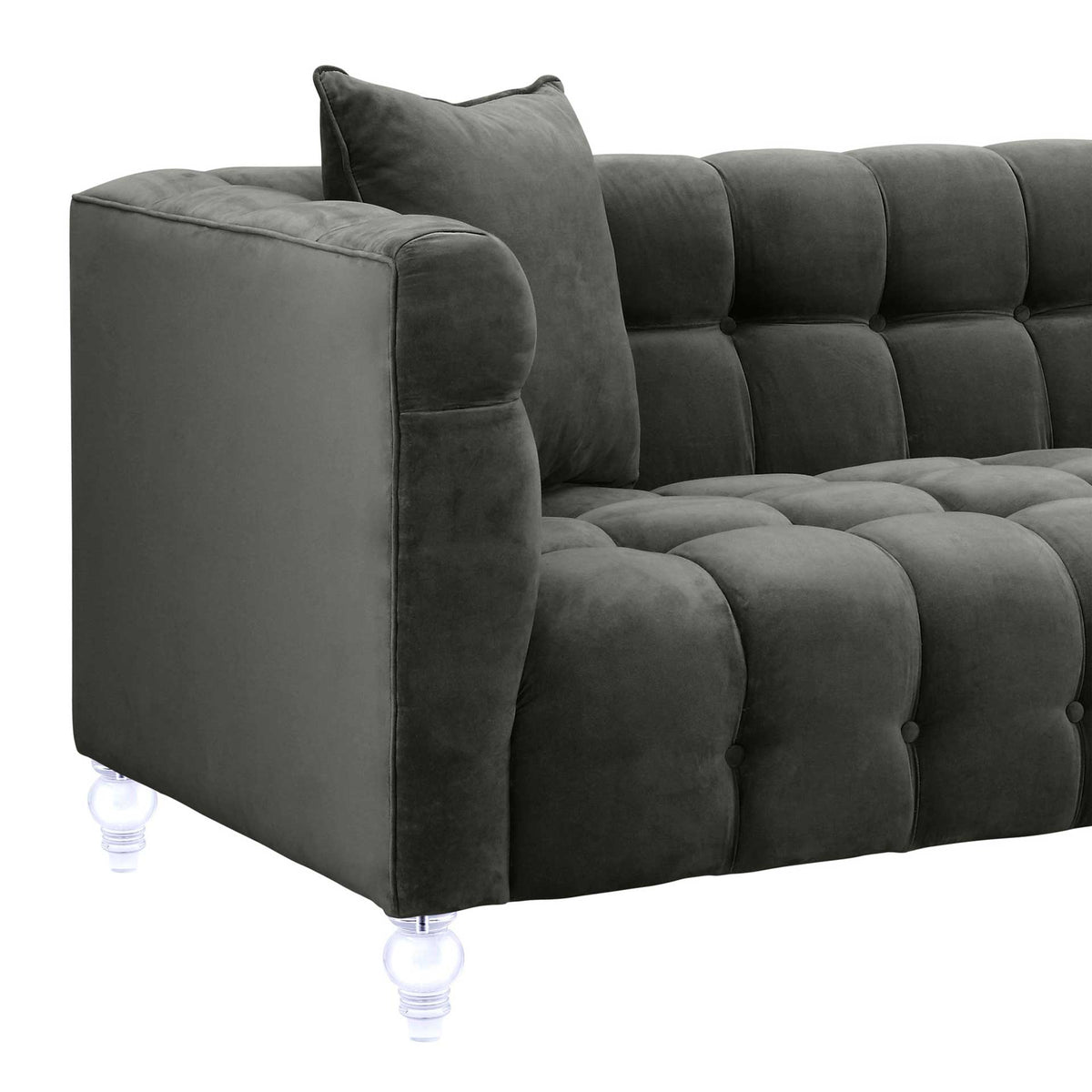 Soft gray velvet, a padded shelter arm, and deep button tufting add cozy texture and tailored style