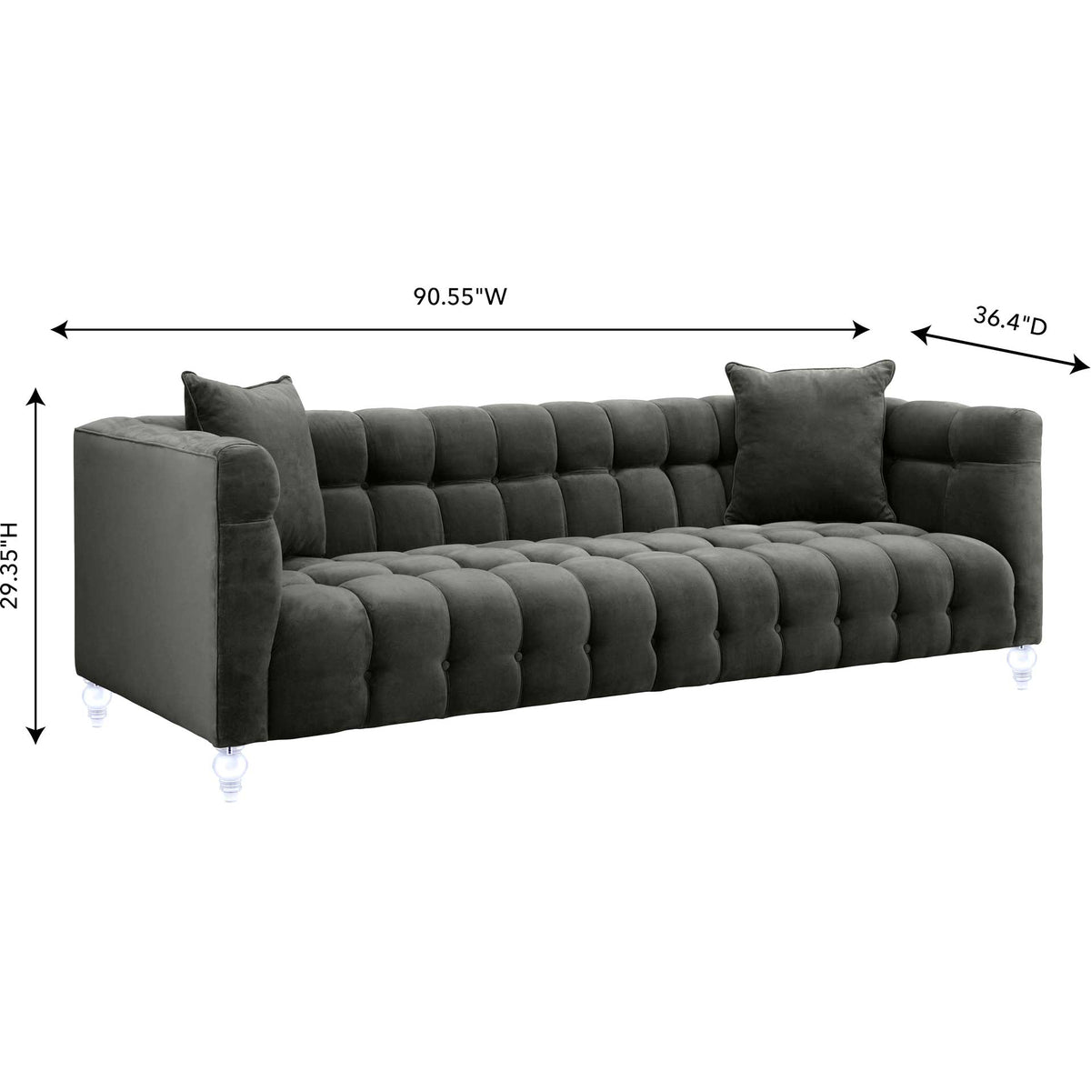 Generous gray velvet sofa with a deep tufted seat, matching pillows, and a low, streamlined profile