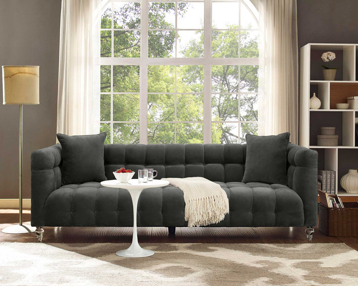 Plush gray velvet seating with deep tufting and coordinating pillows offers inviting everyday comfort