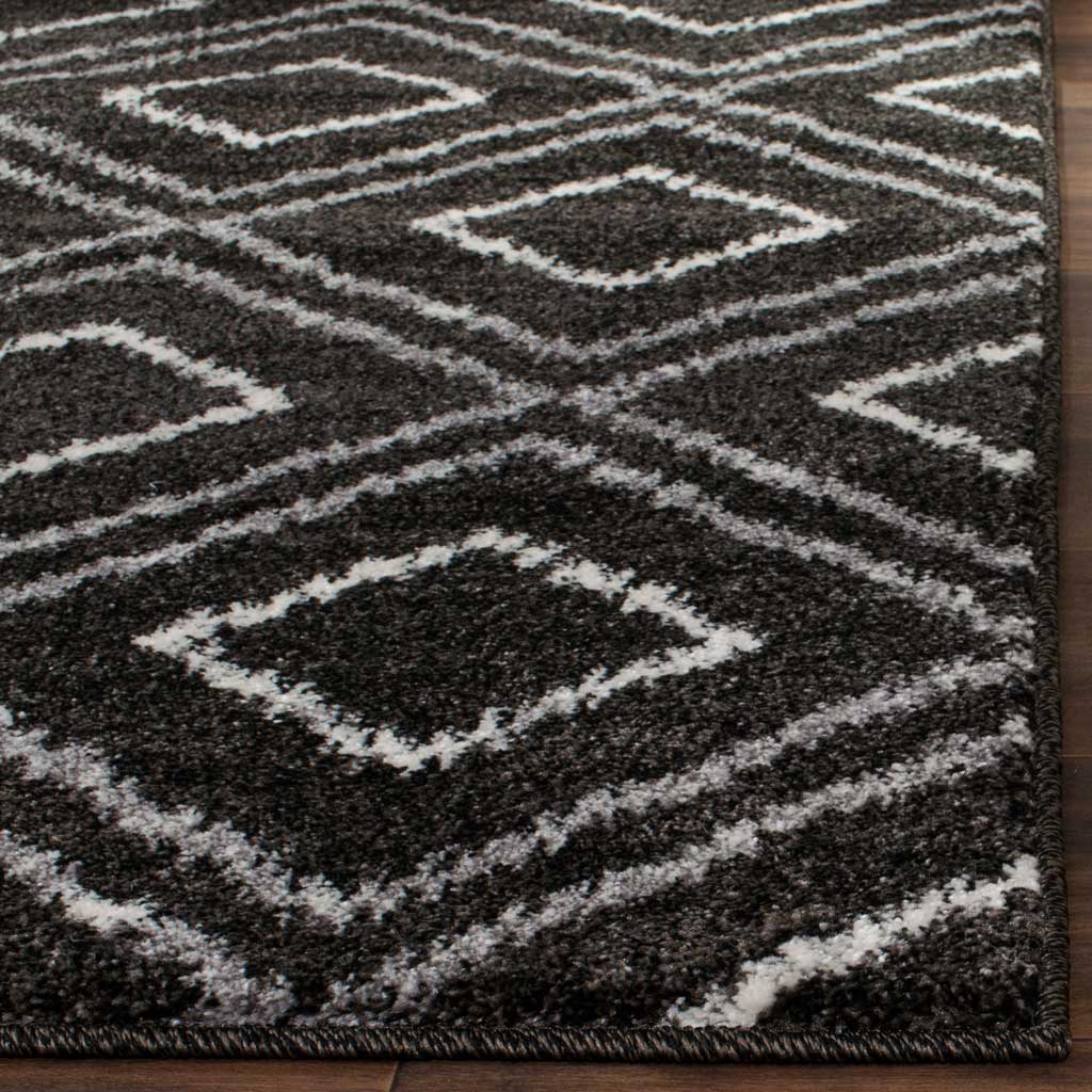 Dense charcoal pile and cream diamond lines meet at a neatly bound edge.