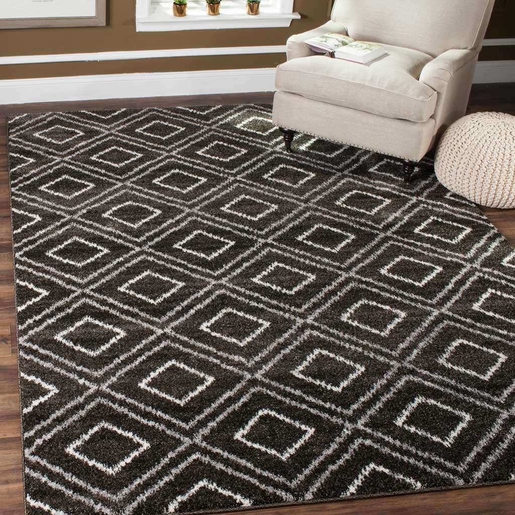 A plush anthracite rug with cream diamonds brings geometric warmth to a cozy room.