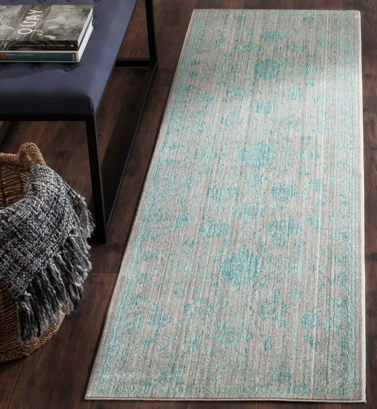 Weathered aqua motifs and a muted neutral ground give this low-profile runner vintage charm