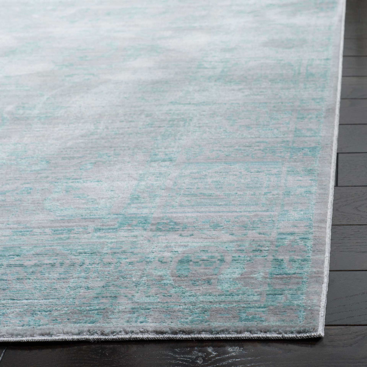 Subtle aqua patterning and neatly bound edges give this rug a polished finish