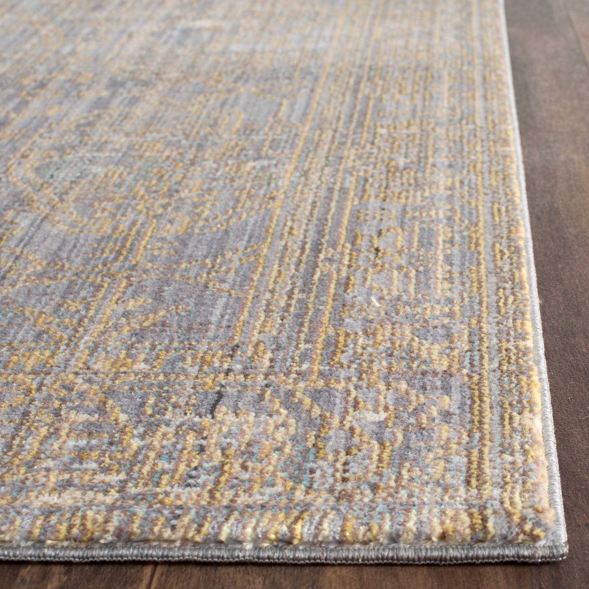 Intricate gold and gray motifs meet neatly bound edges on this low-profile runner rug