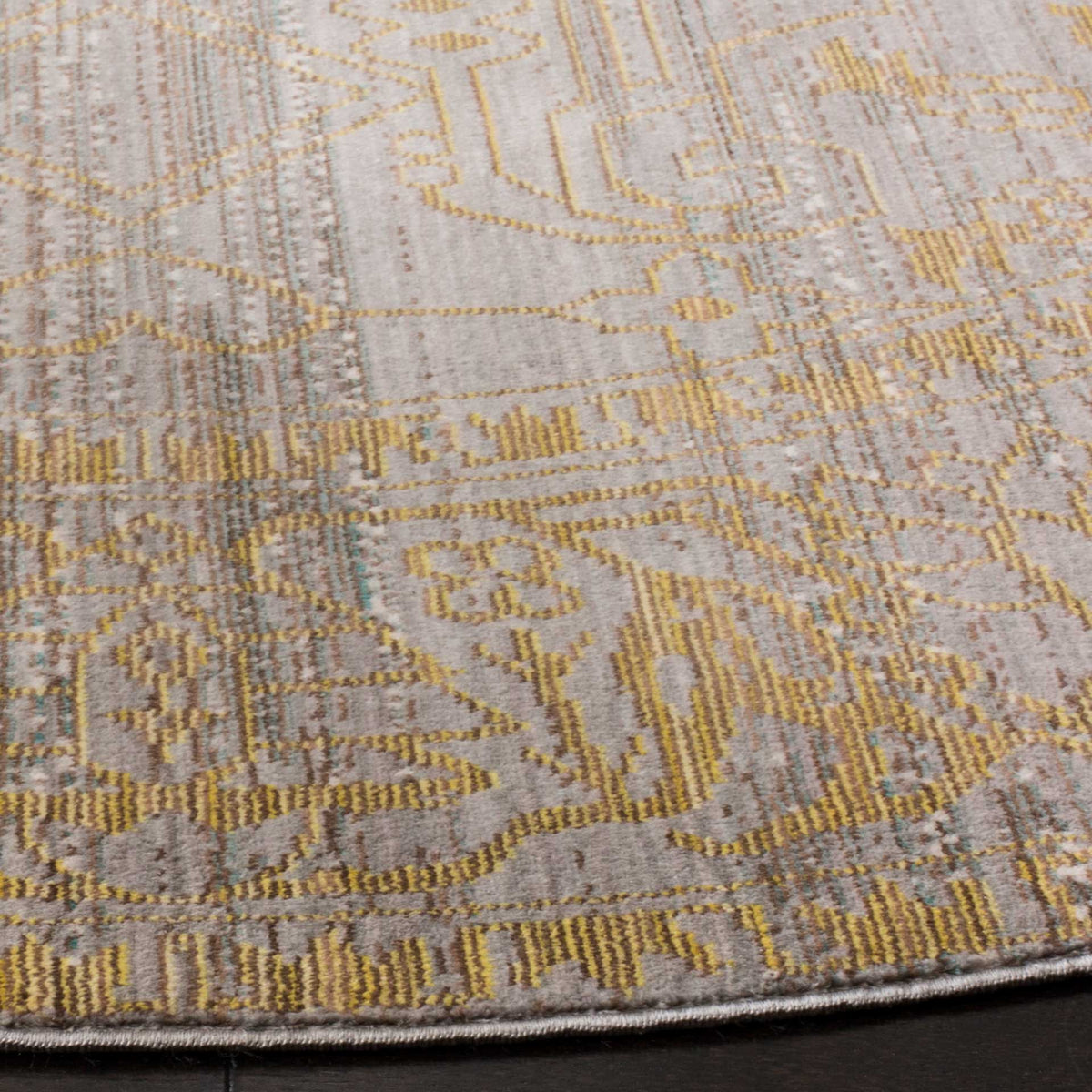 Fine gold motifs enliven a low-profile gray weave with a neatly finished curved edge