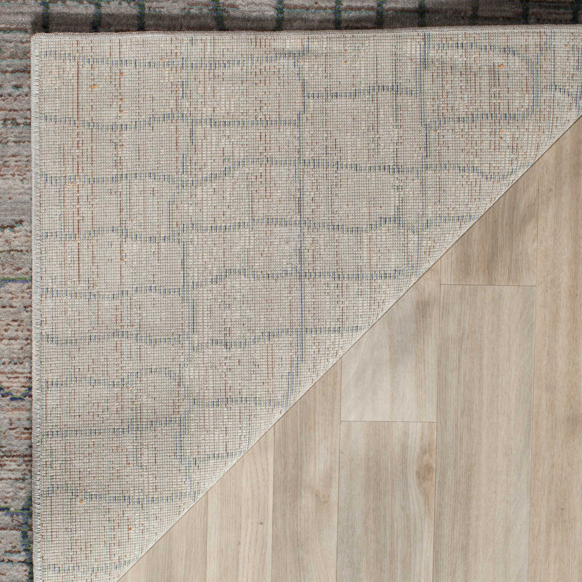 A finely woven cotton backing complements this rug's gray, blue-lined surface